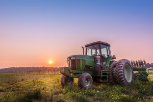 Tractor in a field on a Maryland farm at sunset