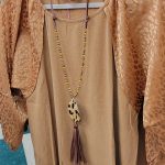 classy gold shirt with silk, animal print sleeves and a matching animal print necklace