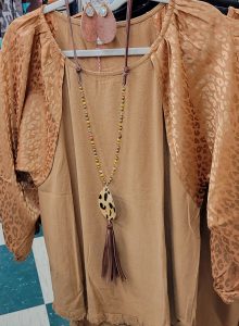 classy gold shirt with silk, animal print sleeves and a matching animal print necklace
