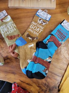 three colorful socks - they say awesome chicken mom, awesome goat mom, and awesome horse mom. 