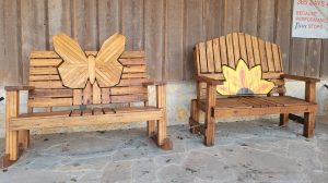 Two wooden handmade rockers/swings, one with a butterfly and one with a painted flower - perfect for a mother's day gift!