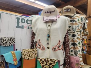 Shirts on display oct 2026 women and mens shirts including Ferrell, colorful purses and hats